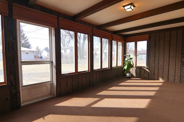 sunroom featuring beamed ceiling