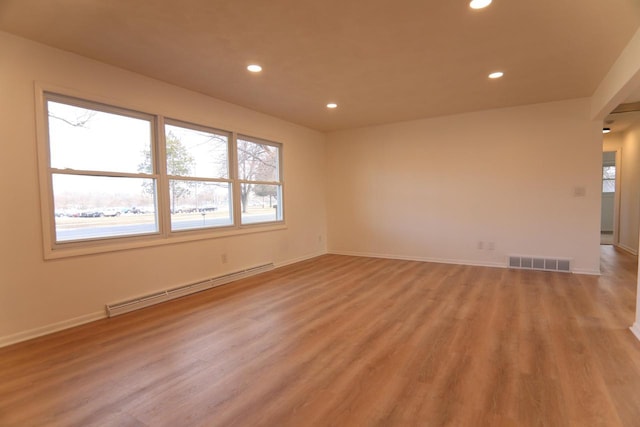 spare room with baseboards, visible vents, recessed lighting, light wood-type flooring, and baseboard heating