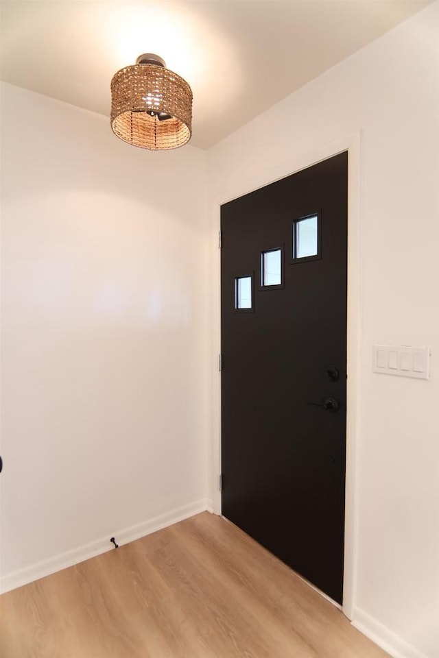 foyer entrance featuring light wood-type flooring and baseboards