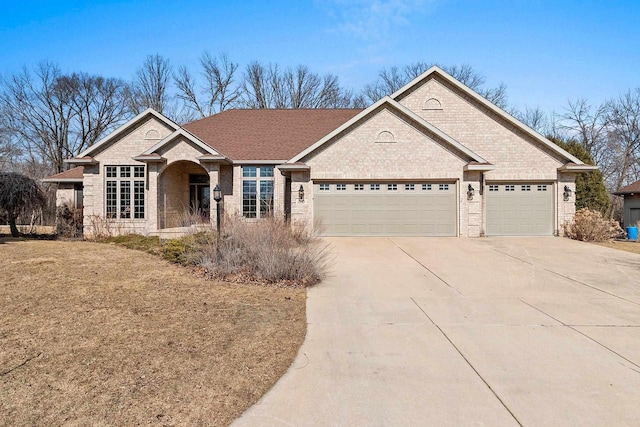 ranch-style home featuring brick siding, concrete driveway, and an attached garage