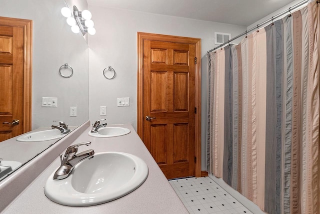 full bath featuring tile patterned floors, visible vents, and a sink