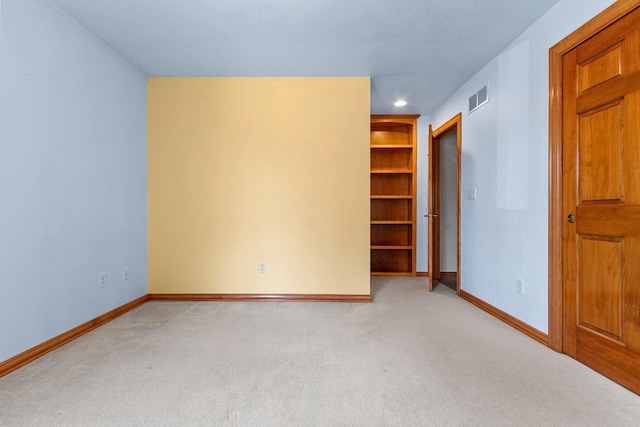 empty room featuring recessed lighting, visible vents, light carpet, and baseboards