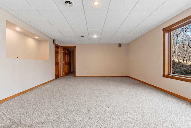 carpeted spare room with recessed lighting, baseboards, visible vents, and a drop ceiling