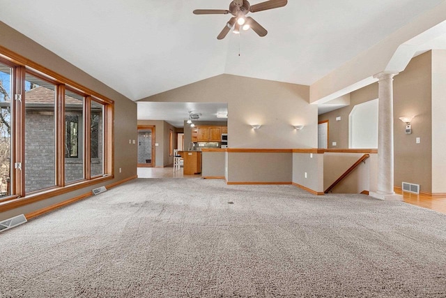 unfurnished living room featuring visible vents, light colored carpet, ceiling fan, and vaulted ceiling