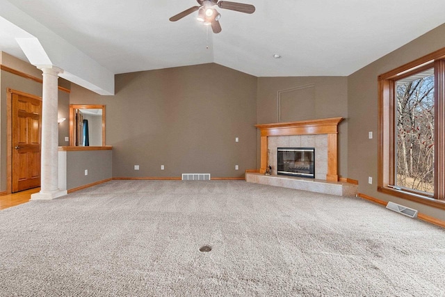 unfurnished living room with vaulted ceiling, carpet flooring, visible vents, and ceiling fan