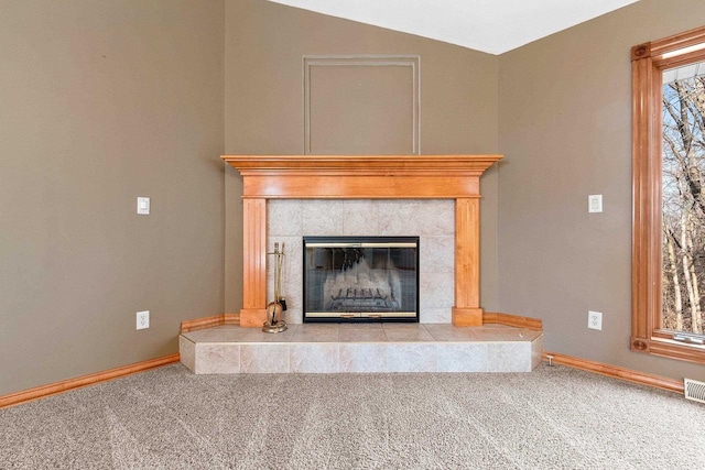 interior details featuring visible vents, a fireplace, baseboards, and carpet floors