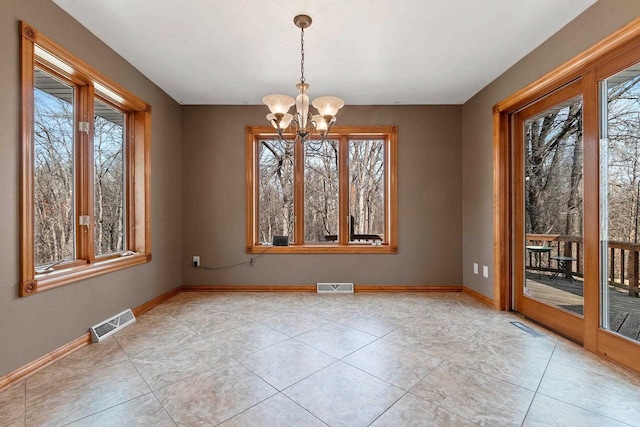 unfurnished dining area featuring baseboards, visible vents, and a chandelier