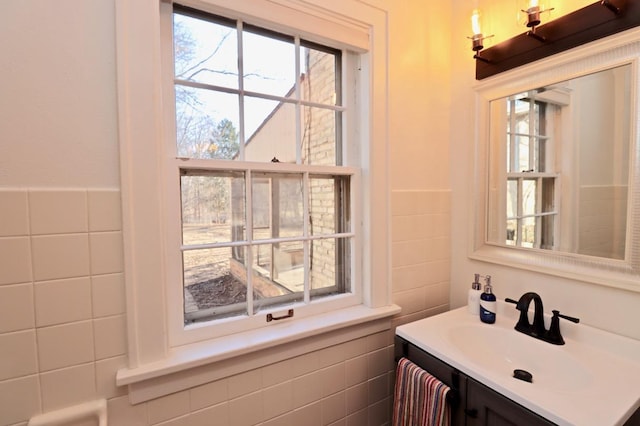 bathroom featuring vanity and tile walls