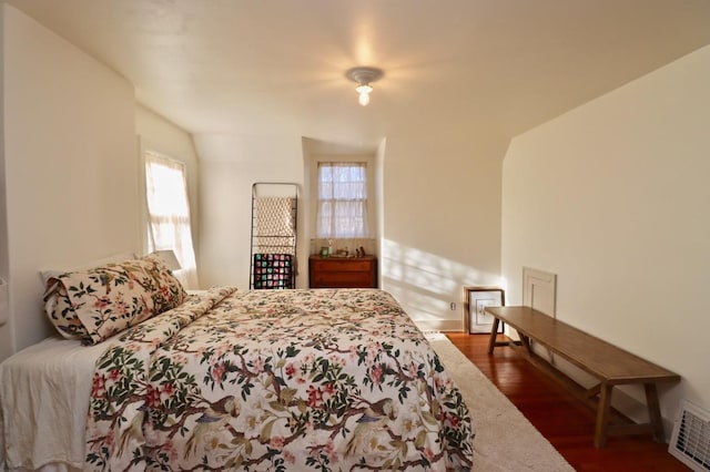 bedroom with visible vents and wood finished floors