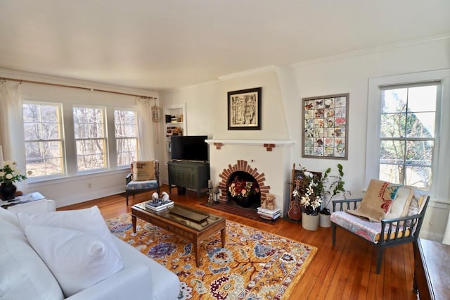 living room with crown molding and wood finished floors