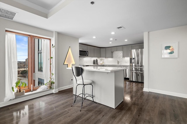 kitchen with visible vents, appliances with stainless steel finishes, and gray cabinetry