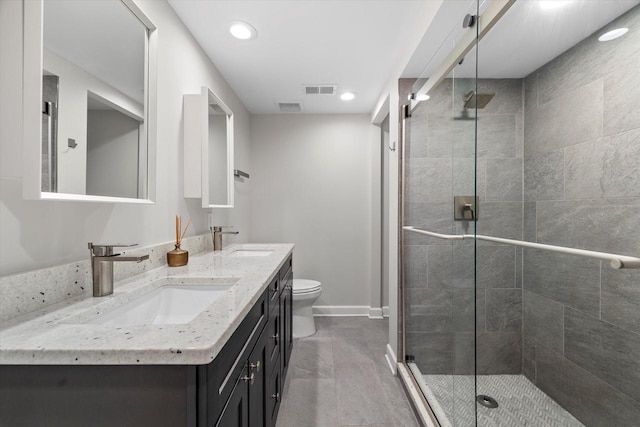 full bath with a sink, visible vents, and a shower stall