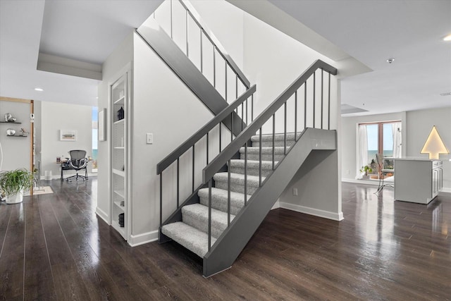 stairway featuring recessed lighting, baseboards, and wood finished floors