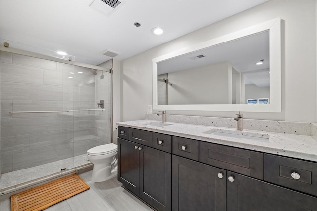 bathroom featuring a stall shower, visible vents, and a sink