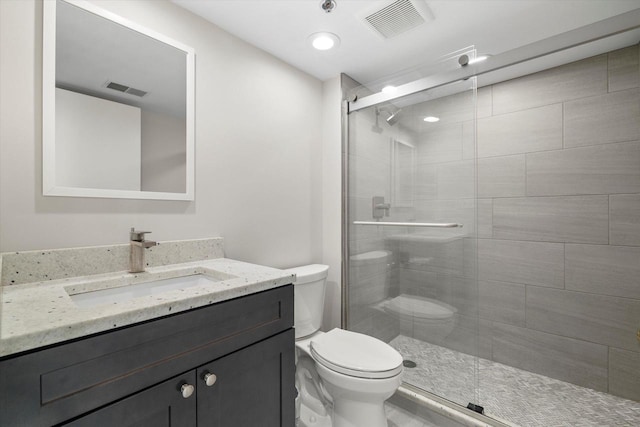 full bathroom featuring a shower stall, toilet, and visible vents