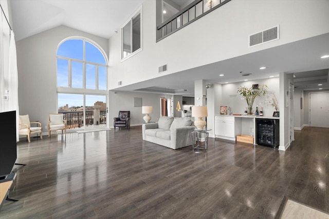 living room with dark wood-type flooring, wine cooler, and visible vents