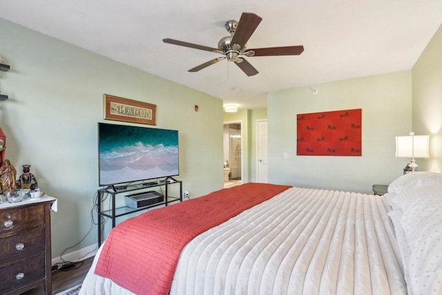 bedroom featuring a ceiling fan, wood finished floors, and ensuite bathroom