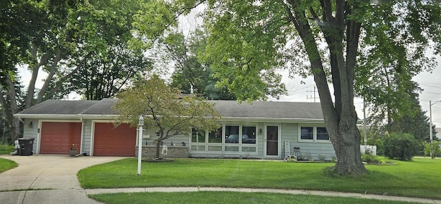 ranch-style house with a front lawn, a garage, and driveway