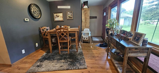 dining space with light wood finished floors, baseboards, and a wealth of natural light