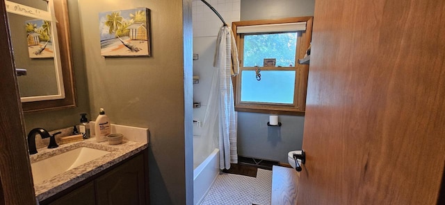 bathroom featuring vanity, shower / bath combination with curtain, and baseboards