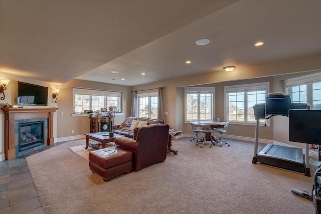 carpeted living room featuring recessed lighting, baseboards, and a fireplace with flush hearth