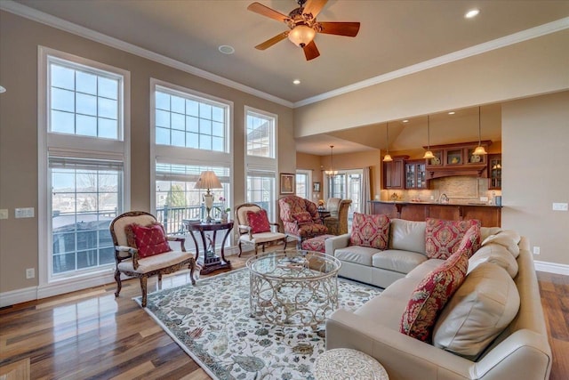 living room with crown molding, baseboards, dark wood finished floors, recessed lighting, and a ceiling fan