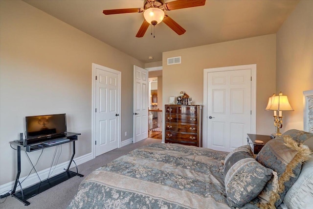 carpeted bedroom featuring visible vents, a ceiling fan, and baseboards