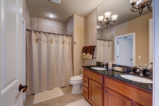 bathroom with a shower with curtain, an inviting chandelier, toilet, and a sink