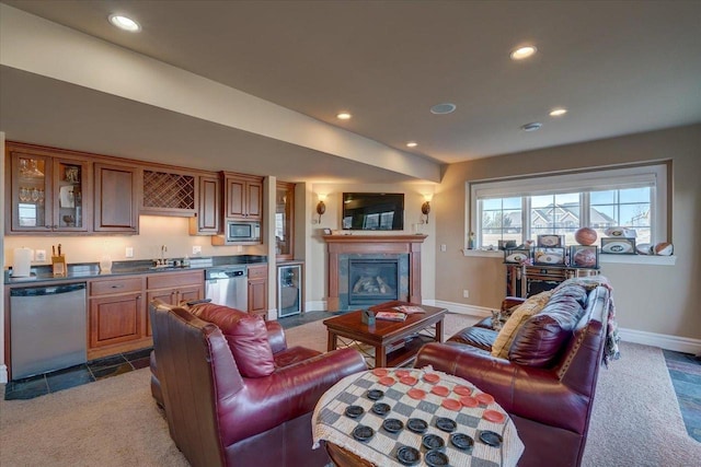 carpeted living room with wet bar, recessed lighting, and beverage cooler