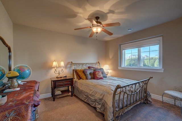 bedroom with light colored carpet, baseboards, and ceiling fan