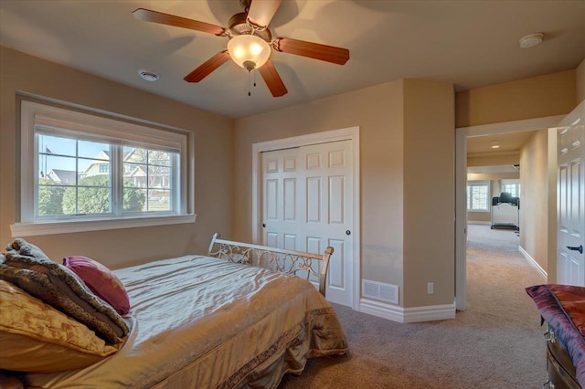 bedroom featuring carpet flooring, baseboards, visible vents, and ceiling fan