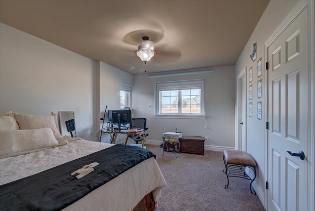 carpeted bedroom featuring baseboards and a ceiling fan