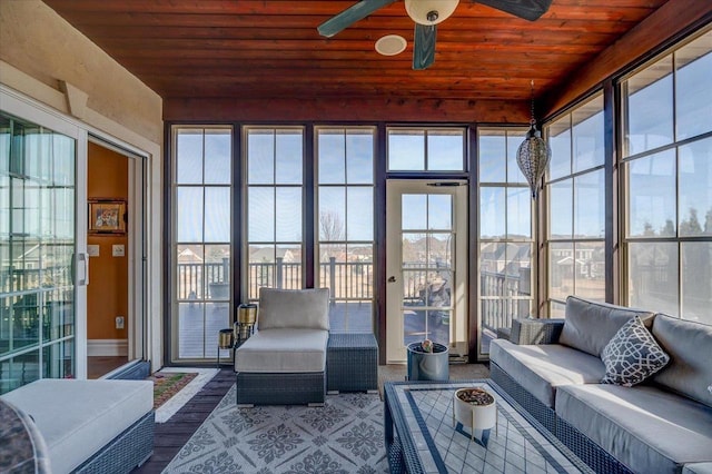 sunroom with wooden ceiling, a ceiling fan, and a wealth of natural light