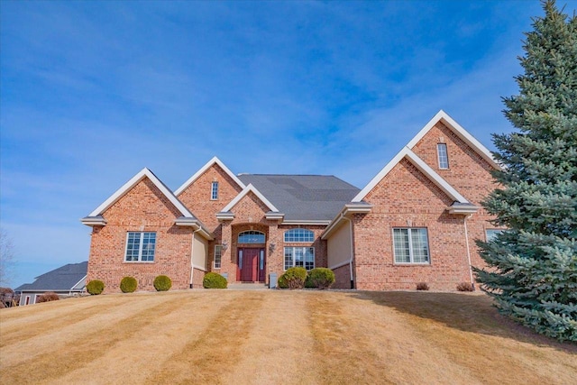 traditional home with a front lawn and brick siding