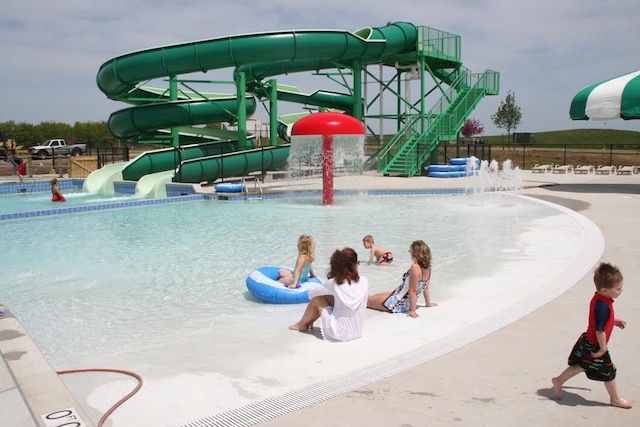 exterior space featuring fence and a water slide