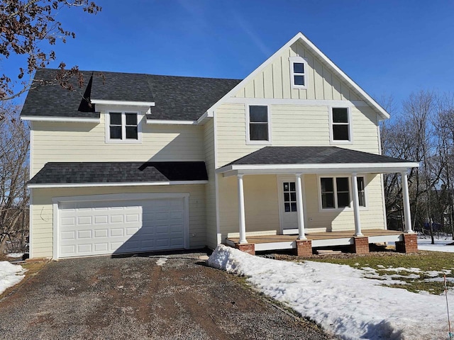 2 S 8th St, Bayfield, WI 54814 - view of front facade with a porch, roof with shingles, board and batten siding, aphalt driveway, and a garage
