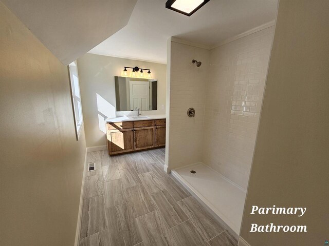 2 S 8th St, Bayfield, WI 54814 - bathroom with baseboards, a tile shower, visible vents, and vanity