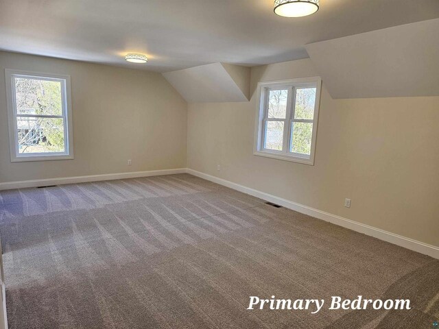2 S 8th St, Bayfield, WI 54814 - bonus room with baseboards, carpet flooring, lofted ceiling, and visible vents