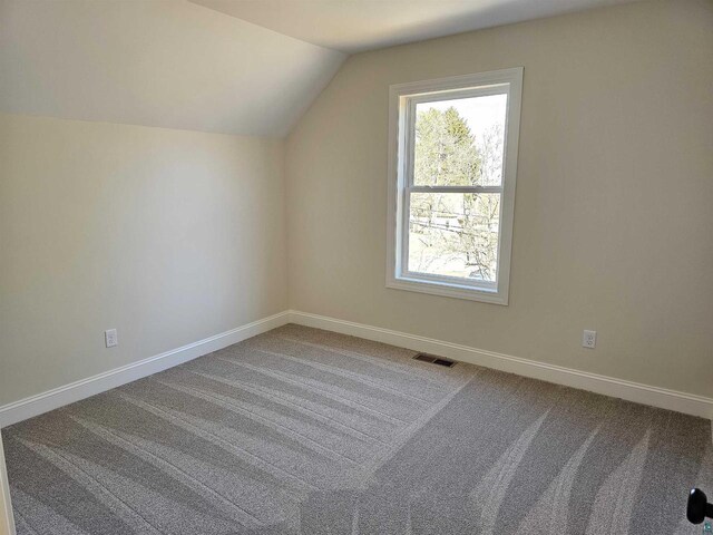2 S 8th St, Bayfield, WI 54814 - bonus room featuring baseboards, visible vents, vaulted ceiling, and carpet