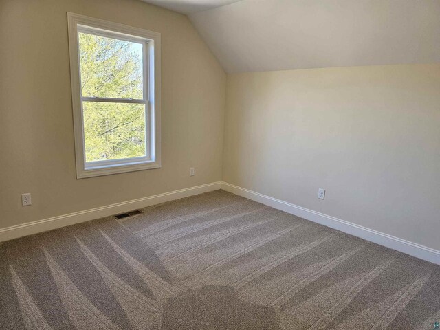 2 S 8th St, Bayfield, WI 54814 - additional living space with carpet floors, baseboards, vaulted ceiling, and visible vents