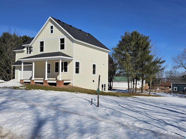 2 S 8th St, Bayfield, WI 54814 - exterior space featuring a garage, board and batten siding, a porch, and roof with shingles