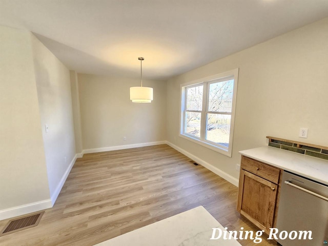 2 S 8th St, Bayfield, WI 54814 - unfurnished dining area featuring light wood-type flooring, baseboards, and visible vents