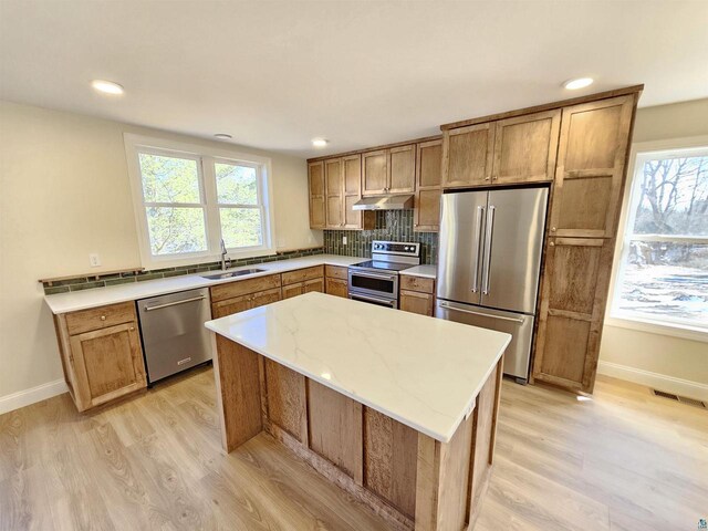 2 S 8th St, Bayfield, WI 54814 - kitchen featuring visible vents, stainless steel appliances, under cabinet range hood, a sink, and light wood-style floors