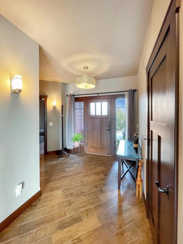 foyer featuring wood finish floors and baseboards