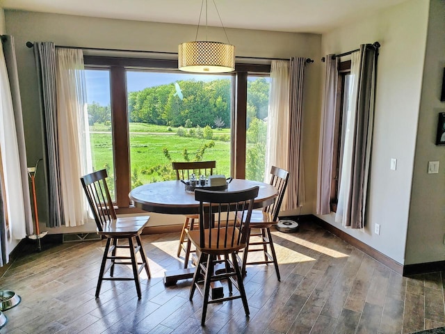 dining area featuring dark wood-style floors and baseboards