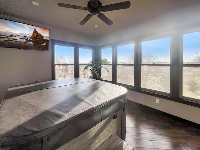 rec room featuring baseboards and ceiling fan