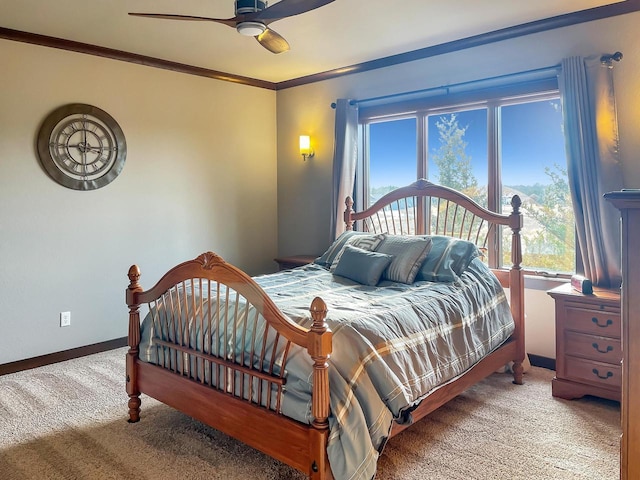 carpeted bedroom with baseboards, ceiling fan, and crown molding