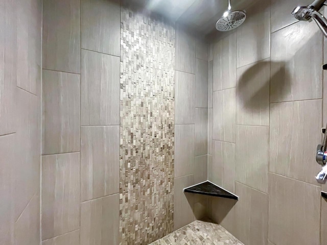 full bath with a tile shower