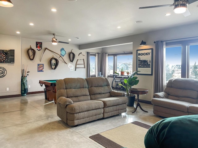 living room with a ceiling fan, recessed lighting, pool table, baseboards, and concrete flooring