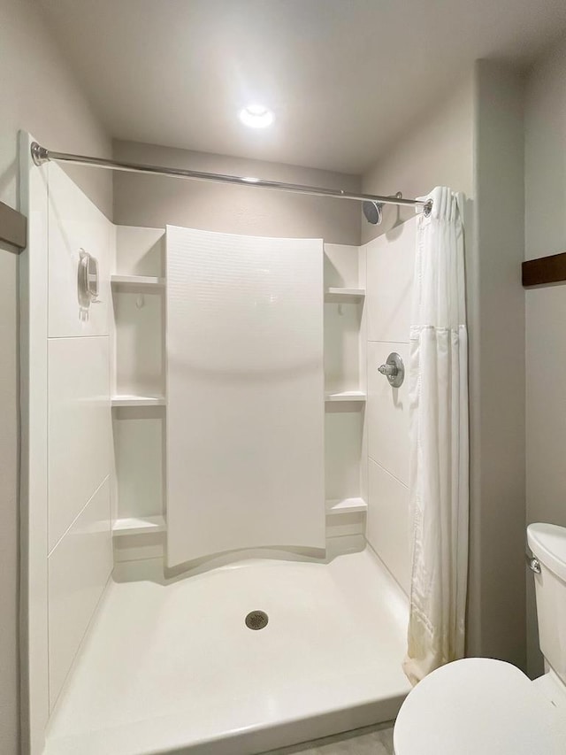 full bath with a shower stall and toilet